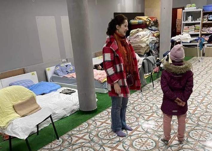 Brown's wife, Katya, speaks with a young refugee girl inside one of their refugee centers in western Ukraine.