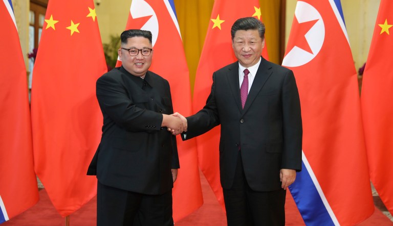 FILE - In this June 19, 2018, file photo released by China's Xinhua News Agency, Chinese President Xi Jinping, right, poses with North Korean leader Kim Jong Un for a photo during a welcome ceremony at the Great Hall of the People in Beijing.