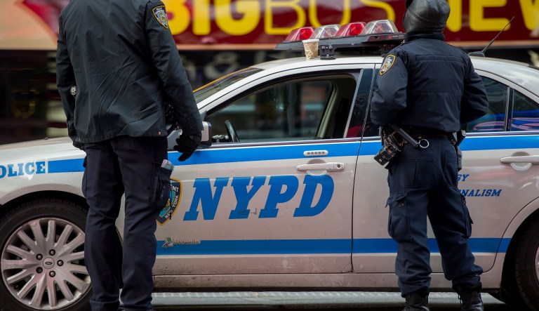 New York Police Department officers stand on patrol in the Times Square area of New York on Monday, Jan. 5, 2015.