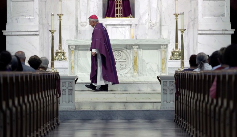 Bishop Ronald Gainer, of the Harrisburg Diocese, walks past the altar as he celebrates mass at the Cathedral Church of Saint Patrick in Harrisburg, Pa., Friday, Aug. 17, 2018.