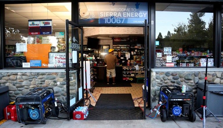 FILE - In this Sept. 24, 2019 file photo, portable power generators and light stands help to illuminate a gas station, though the station's gas pumps were not working in Penn Valley, Calif. PG&E says it could cut off power to a large swath of Northern California later this week to prevent its equipment from starting wildfires during hot, windy weather. The utility says power could be shut off in 30 counties in central and Northern California starting Wednesday, Oct. 9, when hot weather and strong winds are forecast, and through Thursday. (Elias Funez/The Union via AP, File)