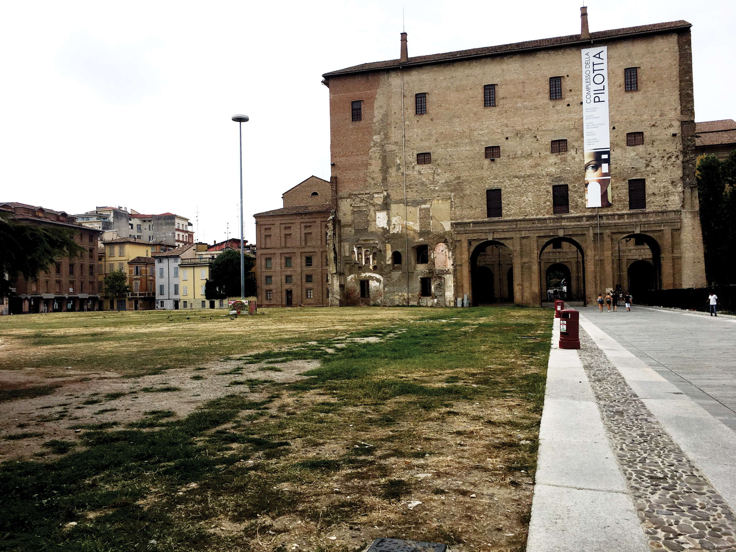 One side of the Pilotta complex, with a decrepit lawn in the foreground