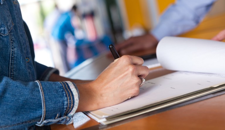 Woman filling out registration form at an event