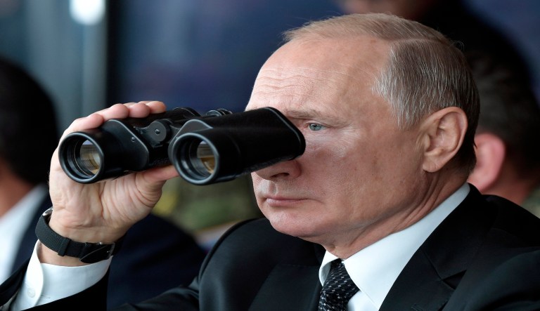 Russian President Vladimir Putin holds binoculars while watching the military exercises Center-2019 at Donguz shooting range near Orenburg, Russia, Friday, Sept. 20, 2019. The main theme of the drills is the use of a coalition army group in the fight against international terrorism and providing military security in Central Asia.