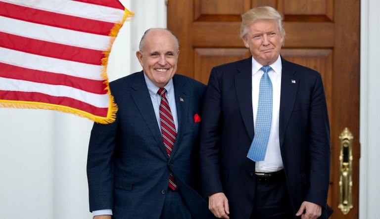 President-elect Donald Trump, right, and former New York Mayor Rudy Giuliani pose for photographs as Giuliani arrives at the Trump National Golf Club Bedminster clubhouse, Sunday, Nov. 20, 2016, in Bedminster, N.J.