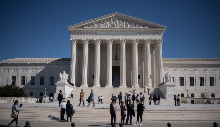 Visitors stand outside the U.S. Supreme Court in Washington, D.C., U.S., on Tuesday, Feb. 27, 2018. The U.S. Senate is expected to approve a sweeping revamp of financial rules this week. Some big banks are lobbying right up to the vote in hopes of salvaging a victory because the legislation probably marks the last time lawmakers with full plates will take up financial regulations before November's crucial midterm elections.