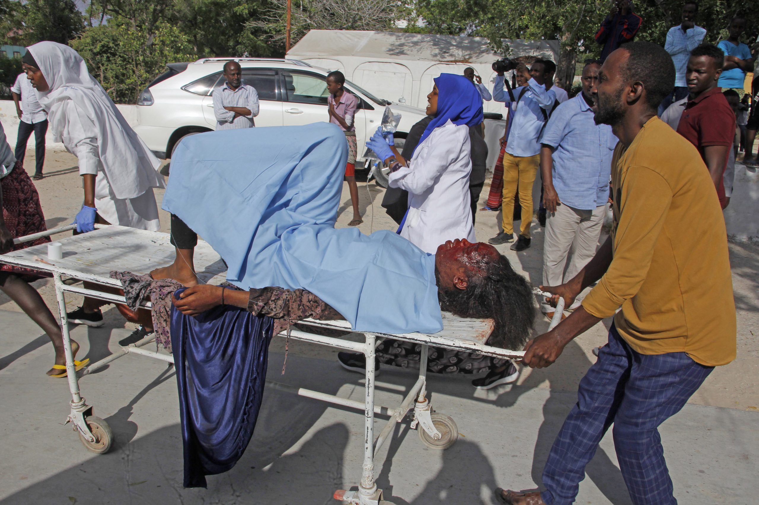 A victim of the attack is carried on a stretcher