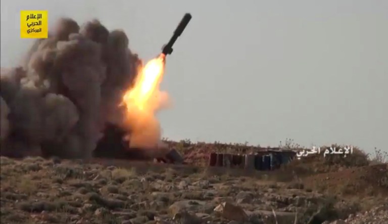 This frame grab from video released on Saturday, July 22, 2017 and provided by the government-controlled Syrian Central Military Media, shows Hezbollah fighters firing a missile at positions of al-Qaida-linked militants in an area on the Lebanon-Syria border. Hezbollah and Syrian troops have said on the second day of military operations that they aim to clear the border area from militant groups.