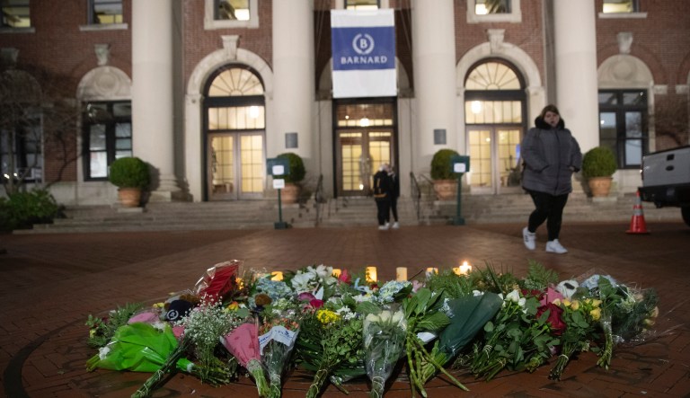 A woman walks past a make-shift memorial for Tessa Majors inside the Barnard campus, Thursday, Dec. 12, 2019, in New York. Majors, a 18-year-old Barnard College freshman from Virginia, was fatally stabbed in a park near the school's campus in New York City.
