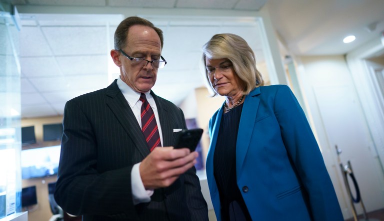 Sen. Pat Toomey, R-Pa., and Sen. Cynthia Lummis, R-Wyo., discuss details of a bipartisan agreement to fix the digital asset reporting requirements in the infrastructure bill, at the Capitol in Washington, Monday, Aug. 9, 2021. 