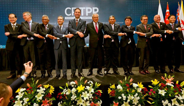 FILE - In this March 8, 2018 file photo, from left, Singapore's Minister for Trade and Industry Lim Hng Kiang, New Zealand Trade Minister David Parker, General Secretary Ministry of International Trade and Industry of Malaysia Y.bhg. Datuk J. Jayasiri, Canada's Minister of International Trade Francois-Philippe Champagne, Australian Minister for Trade and Investment Steven Ciobo, Chile's Foreing Minister Heraldo Munoz, Brunei's Foreign Minister Haji Erawan bin Pehin Yusof, Japan's Trans-Pacific Partnership minister Toshimitsu Motegi, Secretary of Economy of Mexico Idelfonso Guajardo, Peru's Trade Minister Eduardo Ferreyros and Vietnamese Trade Minister Tran Tuan Anh, poses for a pictures after the signing ceremony of the Comprehensive and Progressive Agreement for Trans-Pacific Partnership, CP TPP, in Santiago, Chile.  Japan and New Zealand are cautious about President Donald Trump's idea to re-examine a Pacific Rim trade deal that he pulled the U.S. out of shortly after taking office. Japanese officials said they welcome the move if it means that Trump is recognizing the importance of the Trans-Pacific Partnership. Japan and New Zealand are among 11 countries that signed the agreement after deciding to go ahead without the United States.