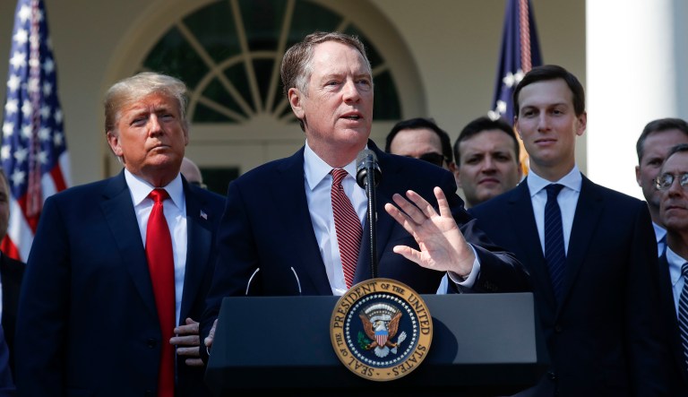 U.S. Trade Representative Ambassador Robert Lighthizer, center, gestures while speaking after President Donald Trump, left, announced a revamped North American free trade deal, in the Rose Garden of the White House in Washington, Monday, Oct. 1, 2018. Also on stage is White House Senior Adviser Jared Kushner, right. The new deal, reached just before a midnight deadline imposed by the U.S., will be called the United States-Mexico-Canada Agreement, or USMCA. It replaces the 24-year-old North American Free Trade Agreement, which President Donald Trump had called a job-killing disaster.