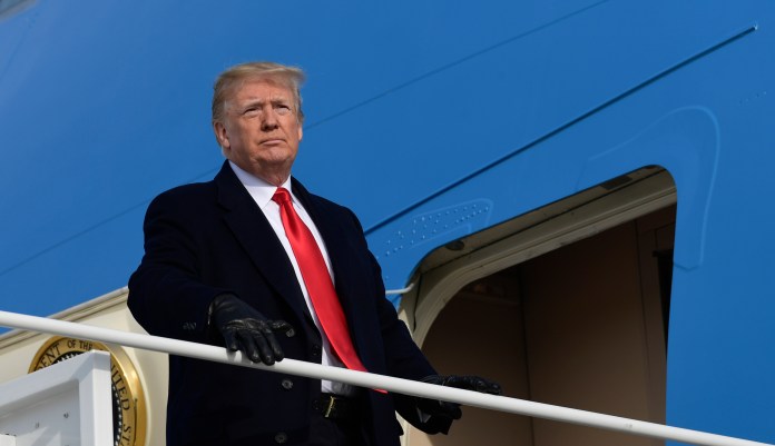 President Donald Trump pauses at the steps of Air Force One at Andrews Air Force Base in Md., Saturday, Dec. 8, 2018. Trump is heading to the Army-Navy Football Game in Philadelphia.