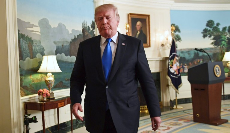President Donald Trump walks from the podium after speaking about Iran from the Diplomatic Reception Room at the White House in Washington, Friday, Oct. 13, 2017. Trump says Iran is not living up to the "spirit" of the nuclear deal that it signed in 2015, and announced a new strategy in the speech. He says the administration will impose additional sanctions on the regime to block its financing of terrorism.