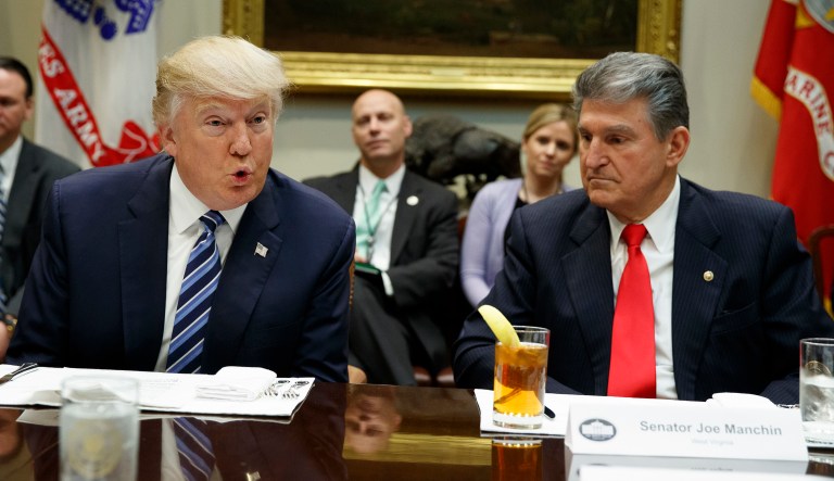 Sen. Joe Manchin, D-W.Va., listens at right as President Donald Trump speaks during a meeting with Senators on his Supreme Court Justice nominee Neil Gorsuch, Thursday, Feb. 9, 2017, in the Roosevelt Room of the White House in Washington.