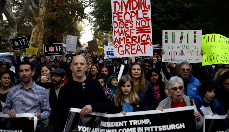Protesters demonstrate near Pittsburgh's Tree of Life Synagogue where President Donald Trump and first lady Melania Trump were visiting a memorial in Pittsburgh, Tuesday, Oct. 30, 2018. The Trumps came to Pittsburgh to honor the victims of a mass shooting at the synagogue last week.