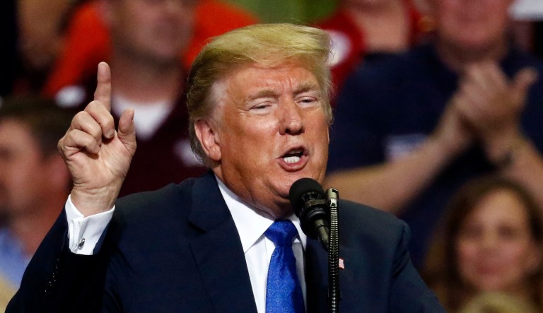 President Donald Trump gestures as he speaks about some Democrats in Congress at a rally Tuesday, Oct. 2, 2018, in Southaven, Miss.