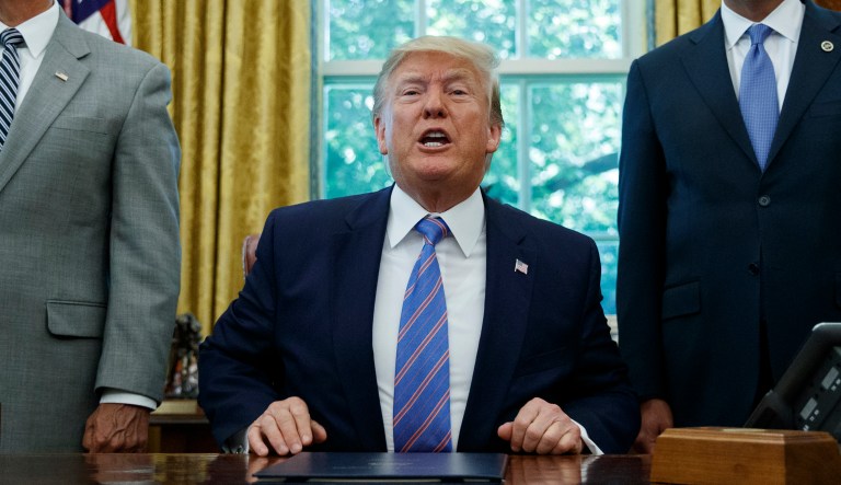 President Donald Trump, joined by Vice President Mike Pence, left, and Secretary of Health and Human Services Alex Azar, right, speaks during a signing ceremony in the Oval Office of the White House in Washington, Monday, July 1, 2019.