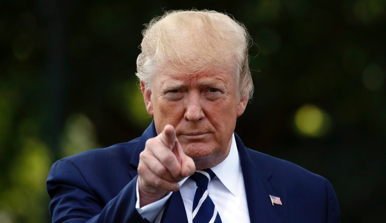 President Donald Trump points as he speaks with reporters on the South Lawn of the White House before departing, Friday, July 19, 2019, in Washington. 