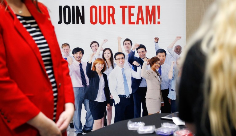 Signage at the Breakthru Beverage Group booth during a National Career Fairs event in Tampa, Florida, U.S., on Wednesday, May 23, 2018. Filings for U.S. unemployment benefits unexpectedly rose to a seven-week high while remaining consistent with a tight job market, Labor Department figures showed Thursday.