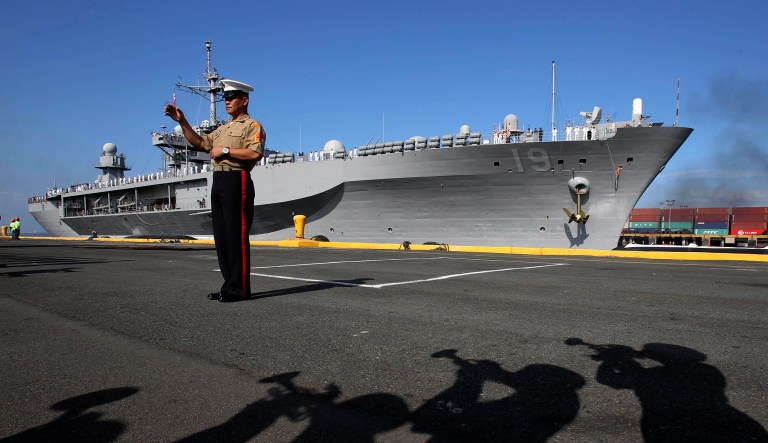 The Philippine Marines band cast shadows as they welcome the USS Blue Ridge to start its goodwill visit Sunday Feb.13, 2011 at Manila's South Harbor in Manila, Philippines. The flagship of the U.S. Navy's Seventh Fleet is on a routine four-day port call and will conduct various civic-military activities in the country.