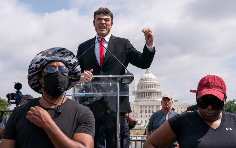 Joe Kent, center, speaks during a 