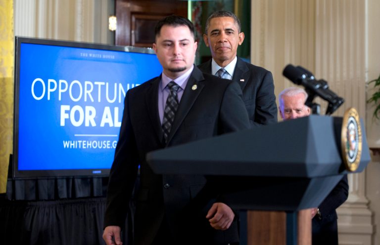 President Barack Obama arrives with PG&E apprentice electrician Erick Varela, a U.S. Army combat infantryman in Iraq, left, and Vice President Joe Biden, right, to the East Room of the White House, Friday, in Washington, to speak about helping the long-term unemployed. (AP/Carolyn Kaster)