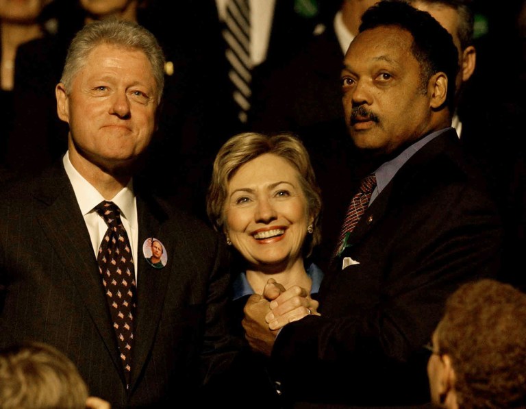 Former President Bill Clinton and his wife, Hillary Rodham Clinton, greet Jesse Jackson before a public memorial service Tuesday, Oct. 29, 2002, in Minneapolis for U.S. Sen. Paul Wellstone. Clinton wrote in a South Carolina newspaper Wednesday that America suffers from systemic racism. (AP Photo/Stacy Wescott)