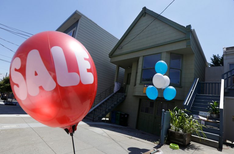 A sale balloon for a nearby store is shown next to a property in the Noe Valley neighborhood just sold for $1.8 million in cash, $600,000 more than its asking price, in San Francisco, Wednesday, July 30, 2014. In the souped-up world of San Francisco real estate, where the median selling price for homes and condominiums hit seven figures for the first time last month, the cool million that would fetch a mansion on a few acres elsewhere will now barely cover the cost of an 800-square-foot starter home. (AP Photo/Jeff Chiu)