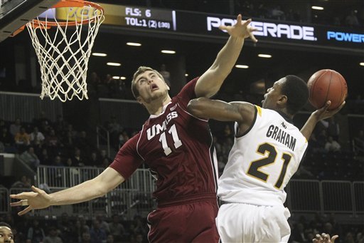 Virginia Commonwealth's Treveon Graham (21) goes up against Massachusetts' Tyler Bergantino during the second half of an NCAA college basketball game in the semifinals of the Atlantic 10 Conference tournament on Saturday, March 16, 2013, in New York. Virginia Commonwealth won 71-62. (AP Photo/Mary Altaffer)