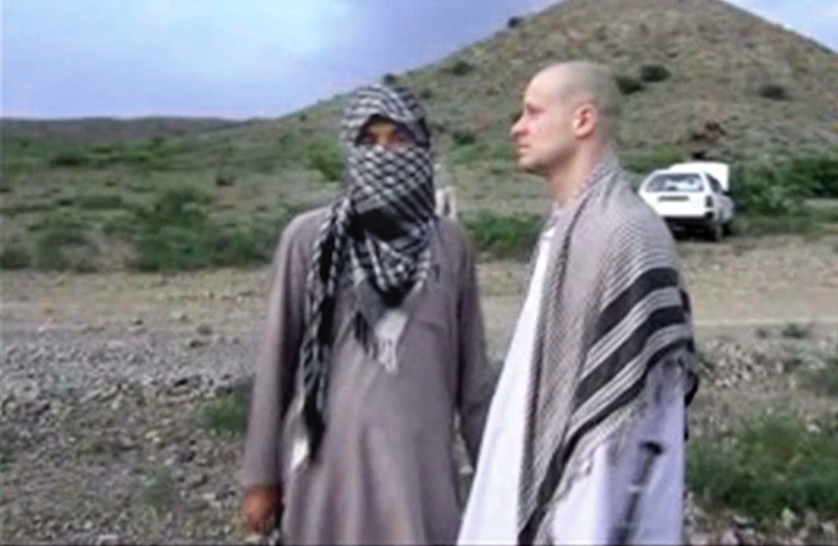 In this Saturday, May 31, 2014 image made from video, U.S. Army Sgt. Bowe Bergdahl, right, stands with a Taliban member in eastern Afghanistan. (AP Photo/Voice Of Jihad)