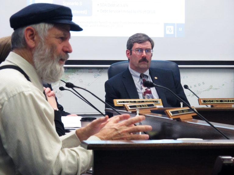 House Resources Committee co-chair Eric Feige, R-Chickaloon, right, listens as Rep. Paul Seaton, R-Homer, speaks during a hearing on the potential fiscal impacts of a major liquefied natural gas project on Wednesday, Feb. 26, 2014, in Juneau, Alaska. (AP Photo/Becky Bohrer)