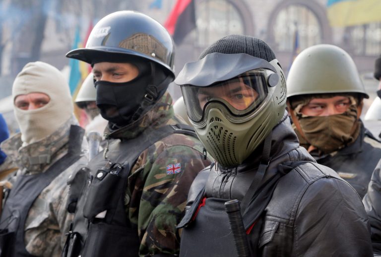 Anti-government protesters, wearing protective head gear, prepare to rally in Kiev's Independence Square, the epicenter of the country's current unrest, in Ukraine, Thursday, Feb. 6, 2014. A senior U.S. diplomat has arrived in the Ukrainian capital to try to help find a resolution to the protests and political crisis that have gripped the country for more than two months. The U.S. Embassy says Assistant Secretary of State Victoria Nuland is to meet President Viktor Yanukovych and leaders of the opposition during her two days in Kiev. (AP Photo/Efrem Lukatsky)