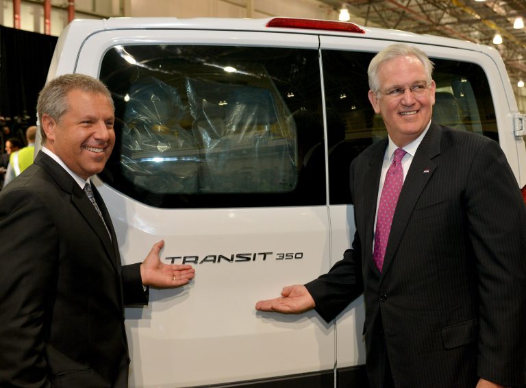 In this photo provided by Ford Motor Co., Joe Hinrichs, President of the Americas, Ford Motor Co., and Missouri Gov. Jay Nixon pose for photos with an all-new Ford Transit at the automaker's Kansas City Assembly Plant in Claycomo, Mo., Thursday, Sept. 25, 2014. The company said Thursday that it's adding 1,200 workers and another shift at the plant. (AP Photo/Ford Motor Co., Sam VarnHagen)