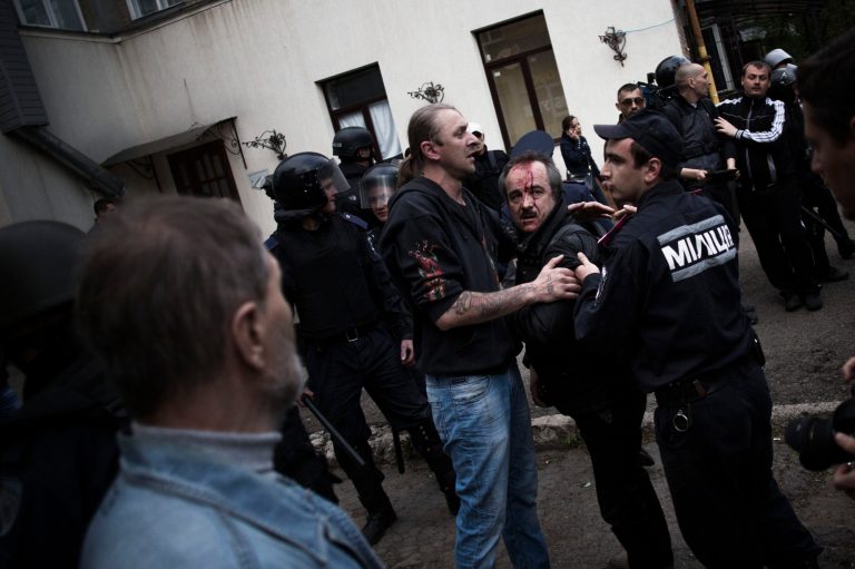 A pro-Ukrainian man bleeds after been beaten by a pro-Russians during a pro Ukraine rally in Donetsk, Ukraine, Monday, April 28, 2014. (AP Photo/Manu Brabo)