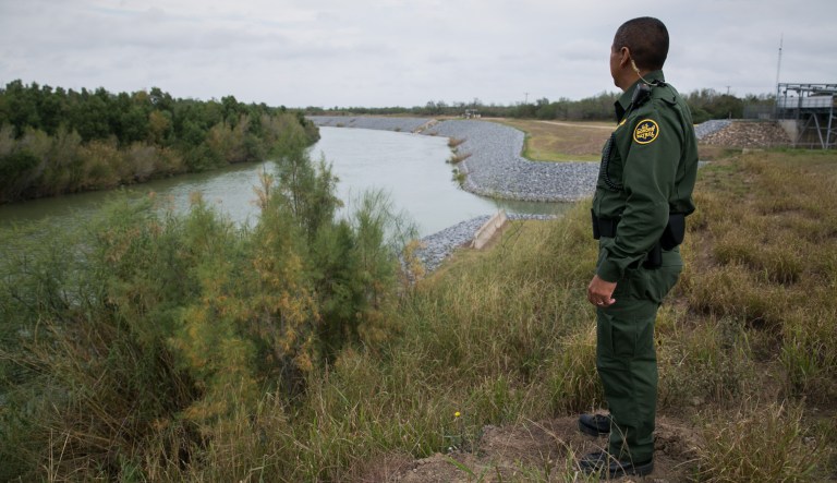 U.S. Border Patrol agent Hermann Rivera looks across the Rio Grande river into Mexico.
