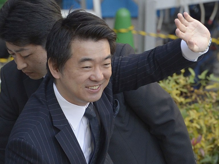   In this Dec. 4, 2012 photo, Japan Restoration Party acting leader Toru Hashimoto waves at his party supporters during his parliamentary elections campaign in Osaka, western Japan. The buzz over Japanâs parliamentary elections this Sunday, Dec. 16, has been all about âthe third forceâ - a clear sign of the prevailing disenchantment over both the party that ruled for decades after World War II and the rival party that took over in 2009. The new party with the most momentum, and one that could be part of the coalition government, is the Japan Restoration Party, led by Tokyo Gov. Shintaro Ishihara and Osaka Mayor Hashimoto, pushing for a more assertive Japan and capable of flexing its military muscle in territorial disputes with China. (AP Photo/Kyodo News) JAPAN OUT, MANDATORY CREDIT, NO LICENSING IN CHINA, FRANCE, HONG KONG, JAPAN AND SOUTH KOREA  
