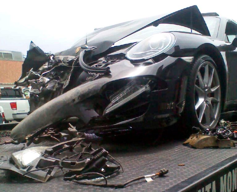   Lindsay Lohan's crashed Porsche lies on a flatbed tow truck, after it collided with a truck on Pacific Coast Highway in Santa Monica, Calif., Friday, June 8, 2012. Santa Monica police say the accident occurred around 11:45 a.m. and an investigation is ongoing. Lindsay Lohan's spokesman says the actress is fine after being released from an area hospital. (AP Photo)  