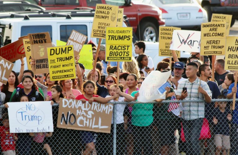 Hundreds of Hispanic residents gather near the battleship USS Iowa on Sept. 15 to protest against Republican presidential candidate Donald Trump, as he delivers a speech on national security aboard the ship. (Kyodo via AP)