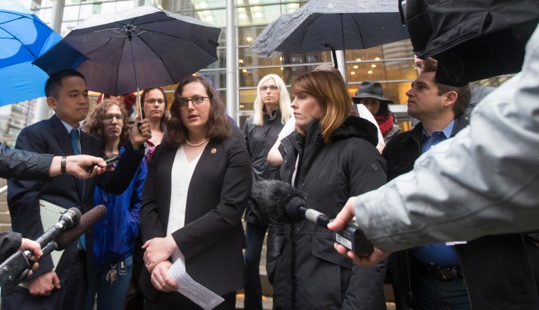 Plaintiff Ssg Katie Schmid, center, speaks while a Lambda Legal senior attorney Peter Renn, Human Campaign communications director Chris Sgro, and Gender Justice League executive director Danni Askini listen following a hearing on a motion for preliminary injunction in the case of Karnoski v. Trump hearing. (Stephen Brashear/AP Images for Human Rights Campaign)