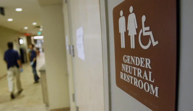 Close-up of a gender-neutral bathroom sign.