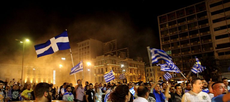   Greeks gather at Omonia square to celebrate the country's win against Russia in the Euro 2012 soccer tournament in central Athens, late Saturday, June 16, 2012. A defensive Greece held off a nearly nonstop Russian attack, putting the 2004 champions into the European Championship quarterfinals and eliminating Russia with a 1-0 victory. (AP Photo/Petros Karadjias)  