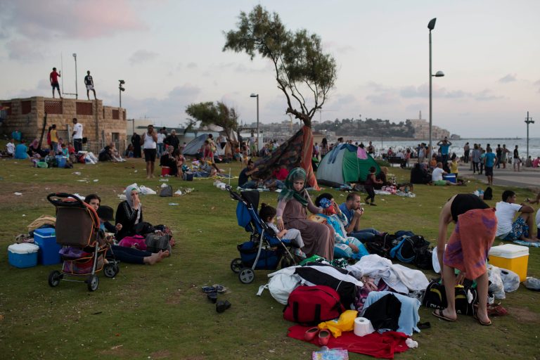 Mostly Palestinians from the West Bank gather at the Tel Aviv beach of Mediterranean Sea on the last day of the Eid-al-Fitr holiday, in Tel Aviv, Israel. The RAND Corp. nonprofit research organization published a new study Monday, June 8, 2015, indicating that Israelis and Palestinians would gain billions of dollars from peace. The findings are in line with long-time arguments that peace is in the economic interest of both sides. (AP Photo/Oded Balilty, File)