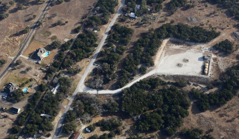 This Dec. 6, 2012 aerial photo shows a natural gas well, right, drilled by Range Resources, but now operated by another company, near homes in rural Parker County near Granbury, Texas. Environmental groups say the White House is siding with the natural gas industry over its own Environmental Protection Agency following a report this week from the EPA's internal watchdog about an investigation of potential groundwater contamination in Parker County from hydraulic fracturing, or fracking.ÃÂ (AP Photo/LM Otero)