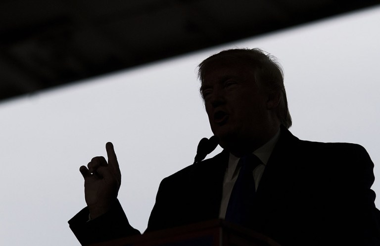Donald Trump is seen in silhouette as he speaks during a campaign rally in Columbus, Ohio -- right before he swept seven of the 11 states voting on Super Tuesday. (Bloomberg/Ty Wright)