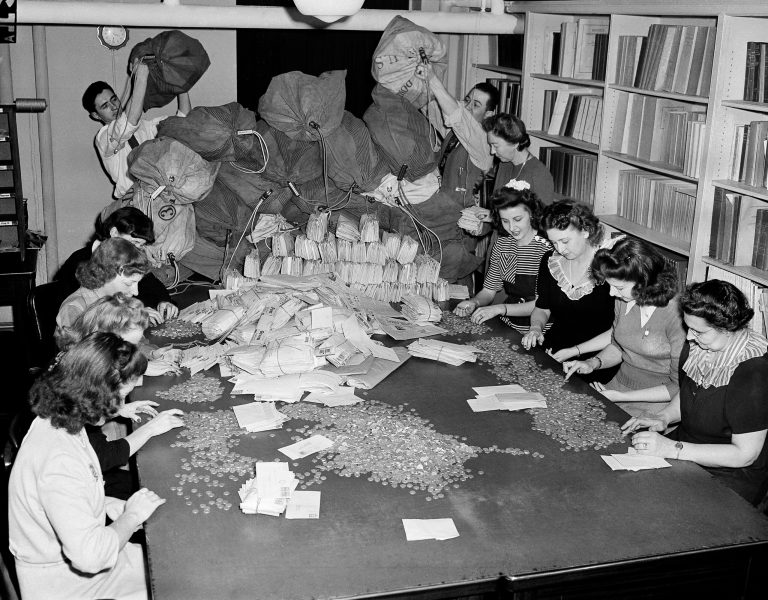 White House employees open letters as more mail piles in containing contributions for the March of Dimes in Washington, D.C., Jan. 28, 1944. (AP Photo)