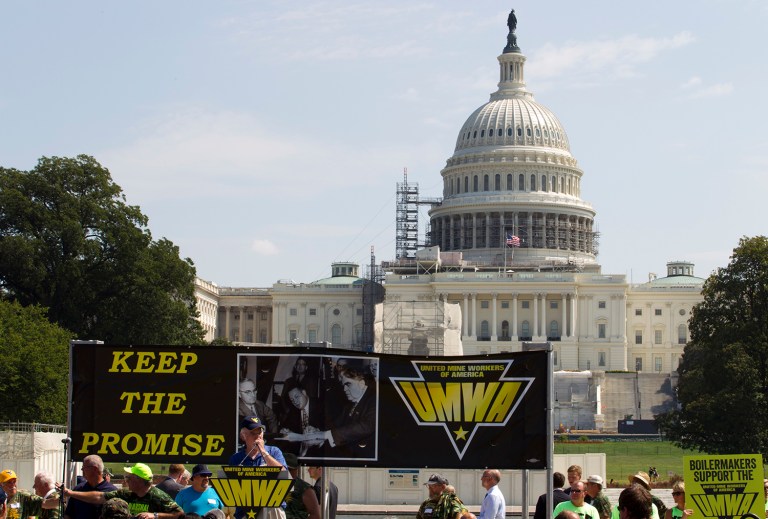 Thousands of unionized mine workers and supporters rallied to push for a bill that would protect healthcare and pension benefits for coal miners and their families. Sens. Joe Manchin and Sherrod Brown stage delaying tactics to get healthcare bill for miners. (AP Photo/Jose Luis Magana)
