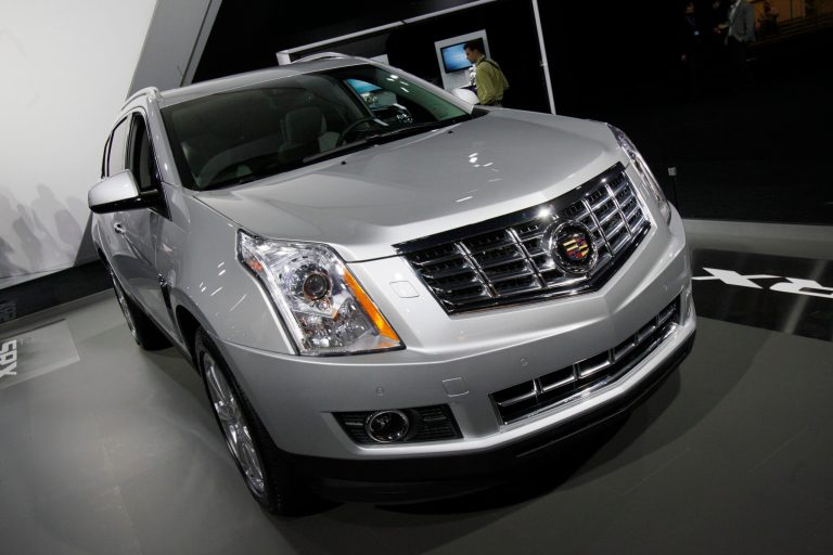 FILE This April 5, 2012 file photo shows the 2013 Cadillac SRX displayed at the New York International Auto Show, in New York.  General Motors announced two more recalls, pushing its total for the year to more than 70, affecting almost 30 million vehicles in North America. The biggest of Friday, Oct. 3, 2014 recalls covers just over 290,000 Cadillac SRX and Saab 9-4X SUVs in the U.S. The company says some rear suspension nuts may not have been tightened properly. That could cause the toe link adjuster to separate from the suspension, possibly causing a crash. (AP Photo/Richard Drew)