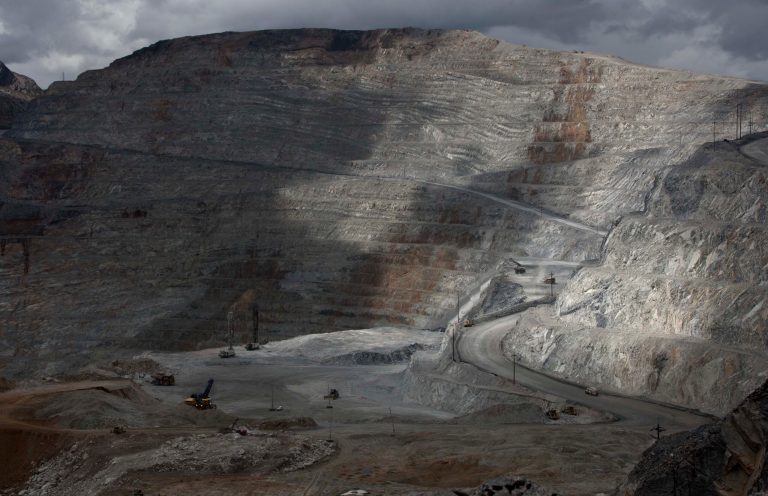 FILE - In this May 14, 2013 file photo, the open-pit Antamina mine in San Marcos, Peru, is partially illuminated on a cloudy day. A new law enacted July 11 by President Ollanta Humala, weakens environmental protections in the Andean nation as it prepares to host international climate-control talks. At the same time, it re-establishes tax breaks for big mining multinationals, which already enjoy such benefits as simultaneous, indefinite concessions for both exploration and exploitation as long as they make nominal payments. (AP Photo/Martin Mejia, File)