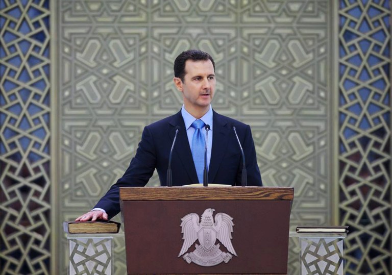 In this photo released on the official Facebook page of the Syrian Presidency, Syria's President Bashar Assad is sworn for his third, seven-year term, in Damascus, Syria, Wednesday July 16, 2014. Proclaiming the Syrian people winners in a 